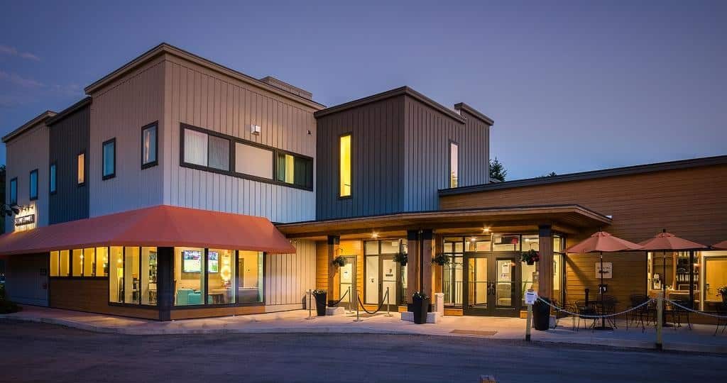 contemporary building at dusk with outdoor seating