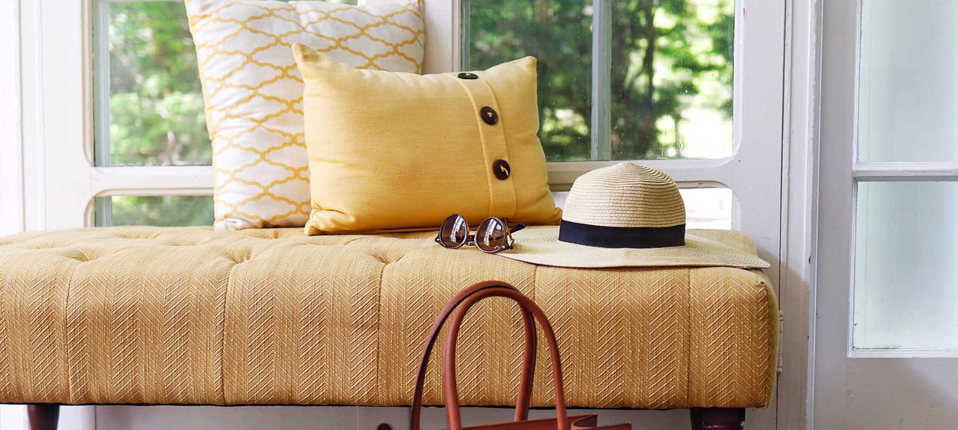 vignette of travel hat and sunglasses in sunroom