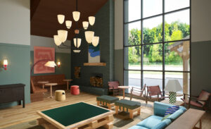 Image of the Lobby at Outbound Stowe with a fireplace, chairs and a center chandelier.