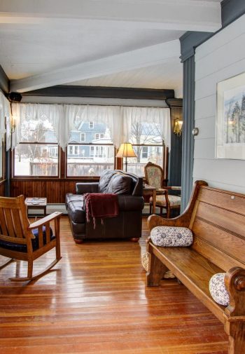 Common sitting room with loveseat, bench, and rocking chair